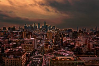 Lower Manhattan as a summer storm swirls, you can feel the energy. New York, City scape, neon, storm, city, summer, night, evening, buildings, skyscrapers, electric, orange