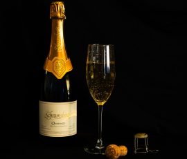 Photo of a bottle of wine, a glass of wine & wine cork.